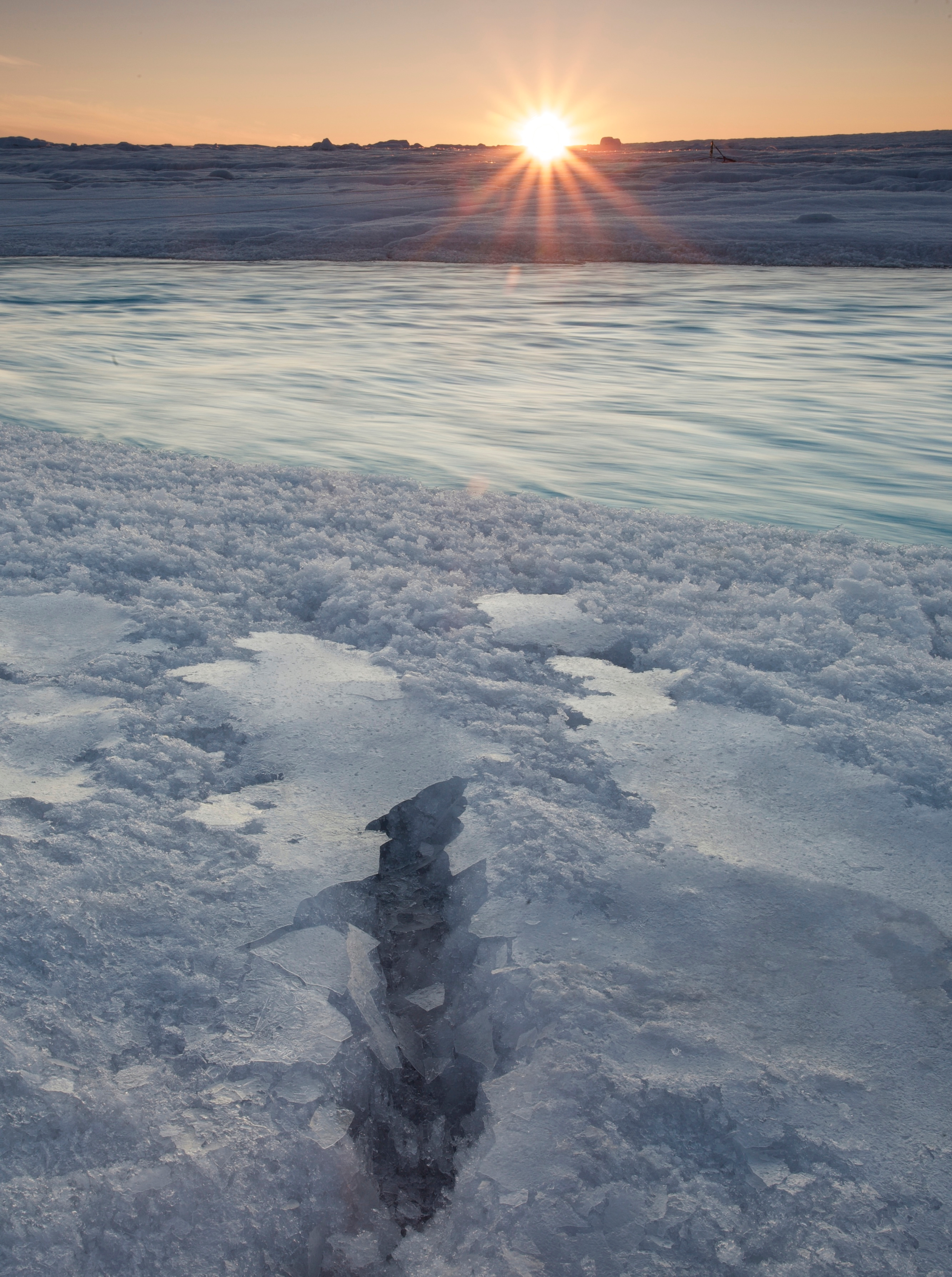 An image of the supraglacial river with refrozen water on the banks.