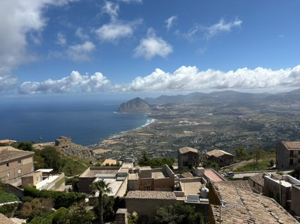 View from high of the coastline, sky and rooftops of buildings.