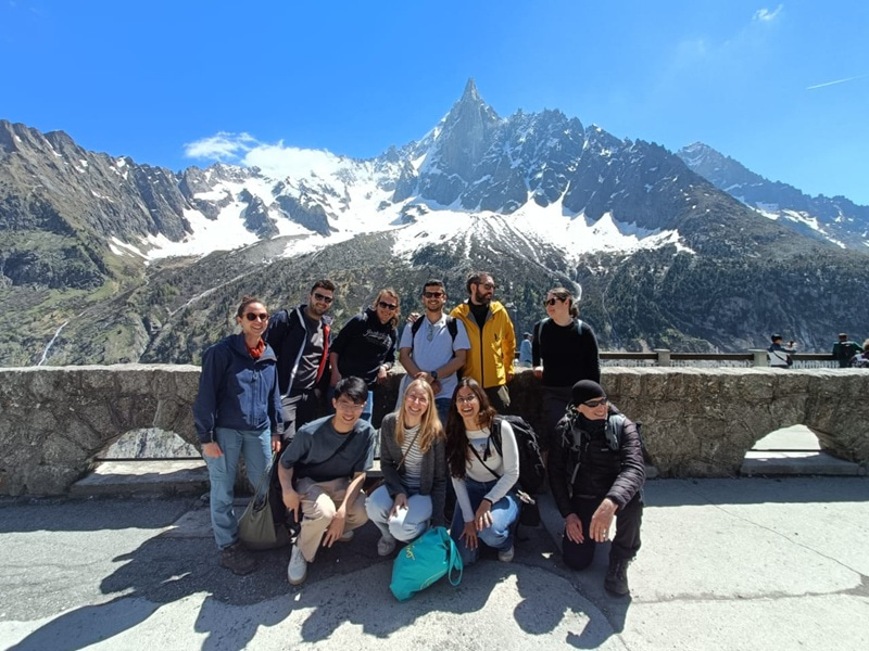 Group photo with mountains in the background.