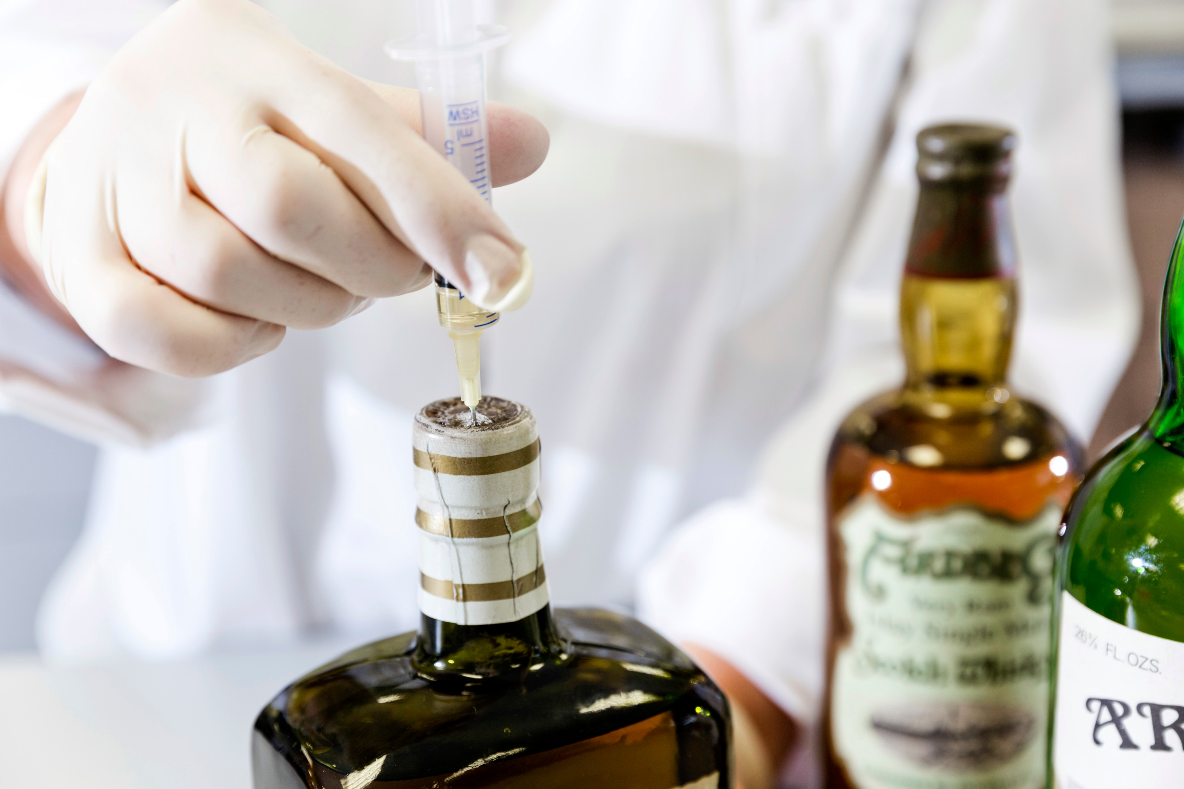 sample being taken from bottle by syringe 