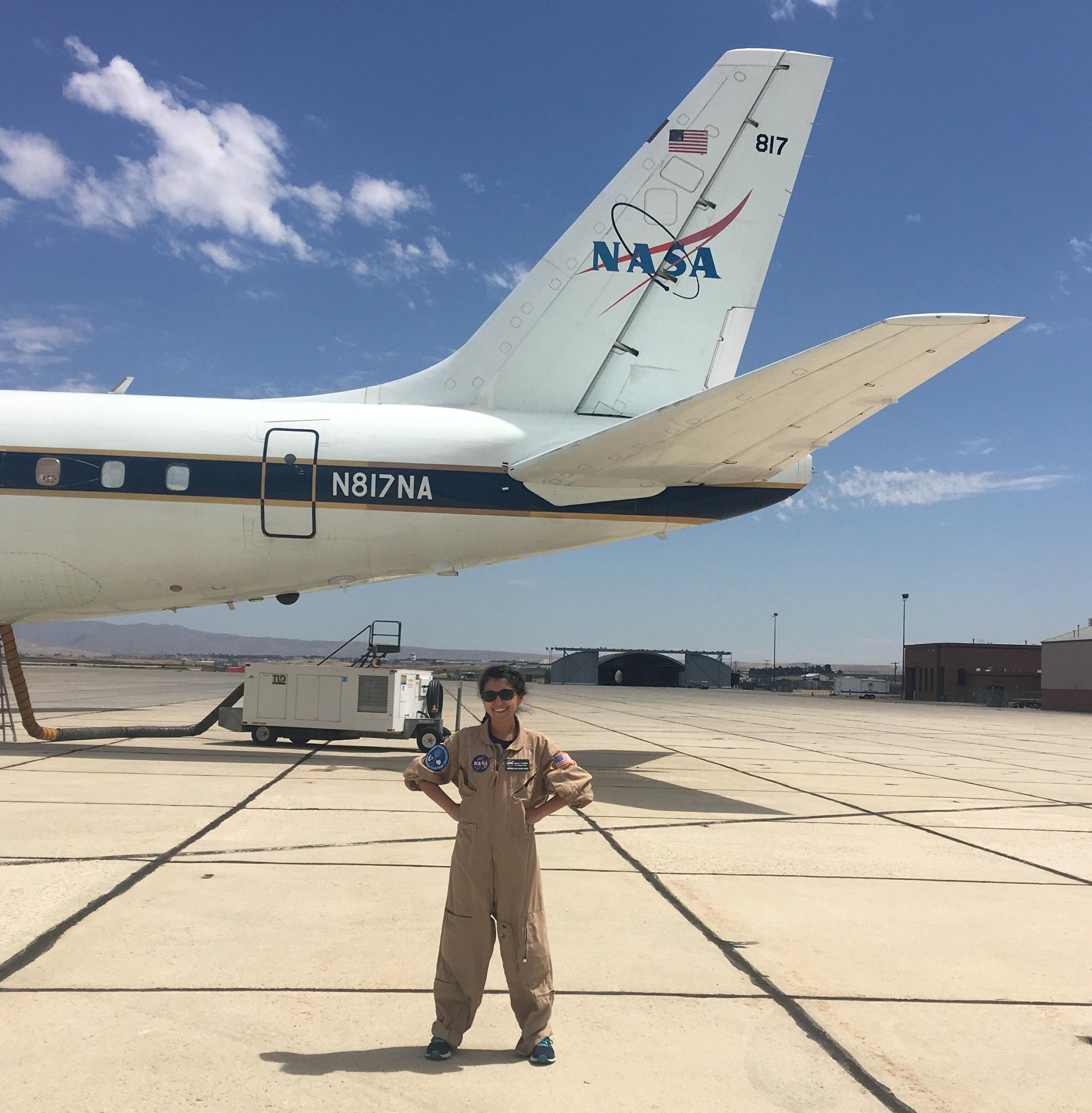 Laura standing in front of the NASA DC-8 research aircraft wearing a NASA flight suit