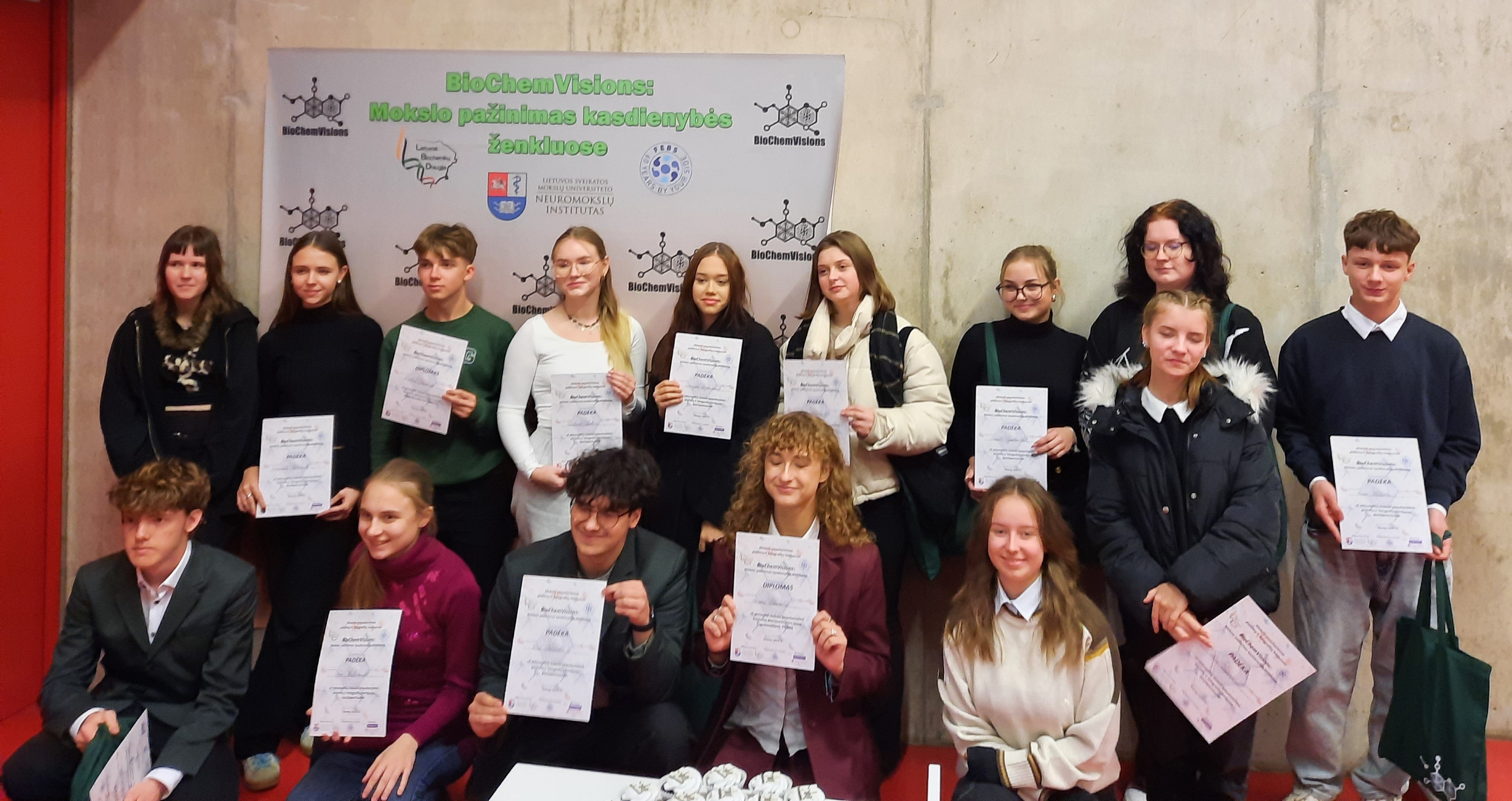 Group photo showing children in rows, holding certificates.