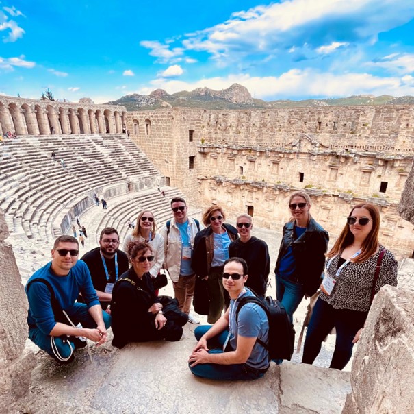 Group photo of participants at the FEBS ETC from the Faculty of Pharmacy and Biochemistry University of Zagreb, with ruins at Antalaya showing in the background.