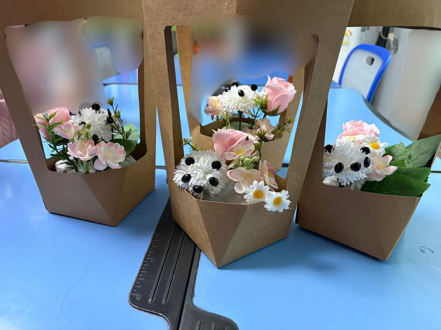 Final results of the workshop: cute panda flower baskets.