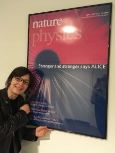 Iulia Georgescu in front of a Nature Physics poster
