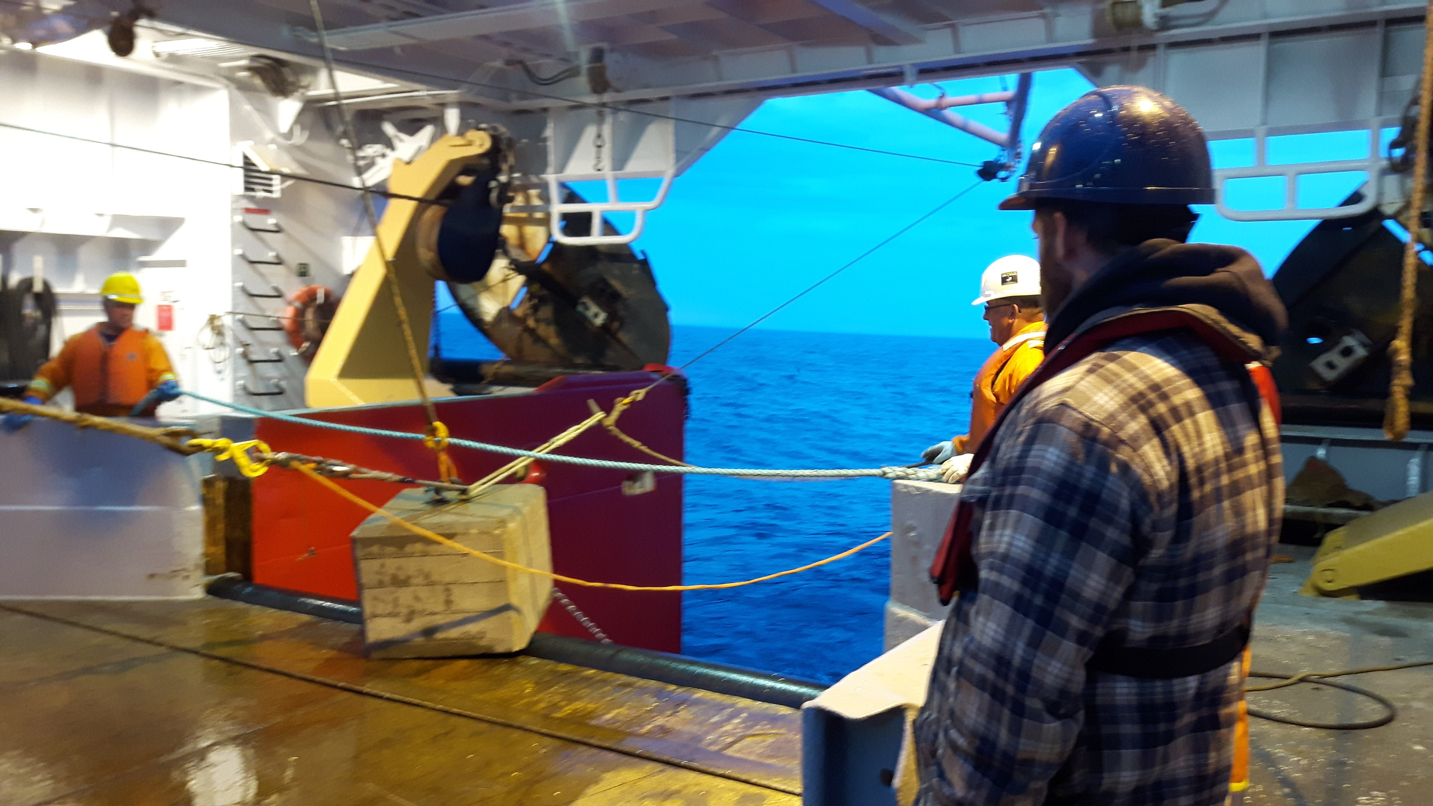 Scientists watching the deployment of the anchor of an oceanographic mooring. This type of instrumentation is used to monitor the state of the AMOC.
