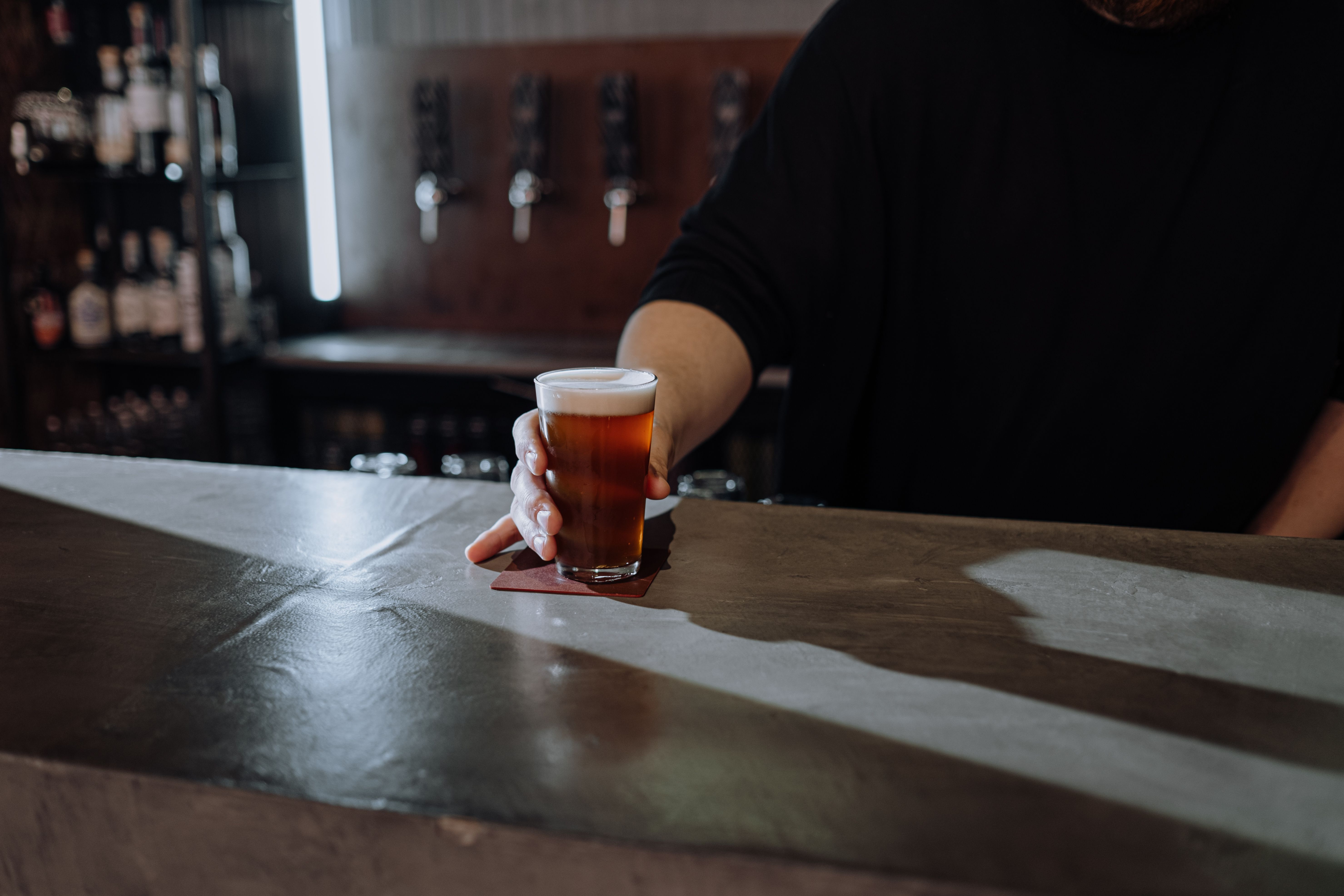 A full pint glass on a bar