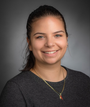 Portrait photo of Charlotte Bellamy, smiling to the camera.