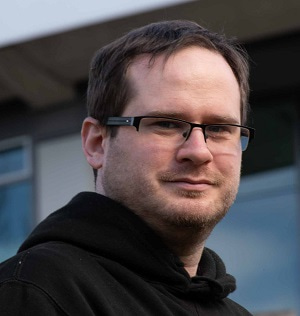 Portrait photo of Dr Laszlo Dobson facing the camera.