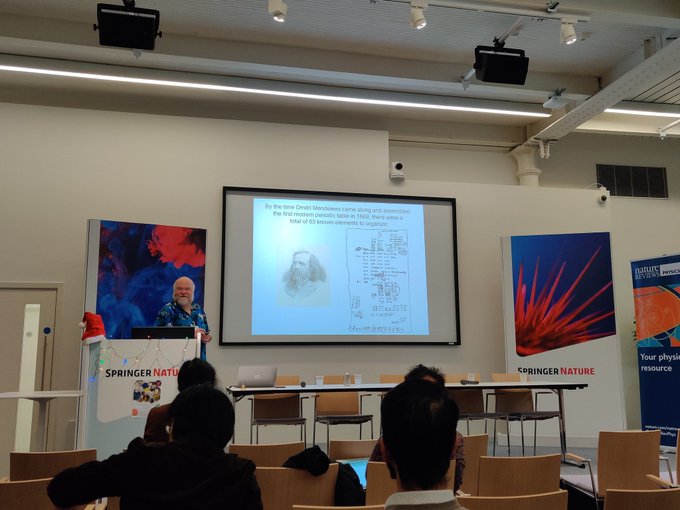 Mark Vagins giving his presentation in front of a screen and Springer Nature banners