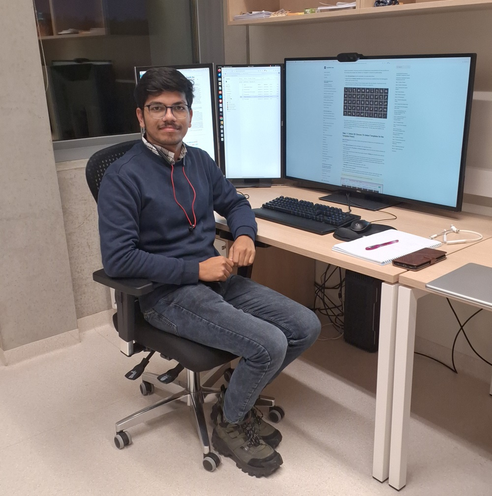 Bablu Kumar sitting at a desk with a computer.