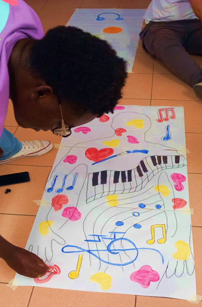 Young person create a painting on white paper