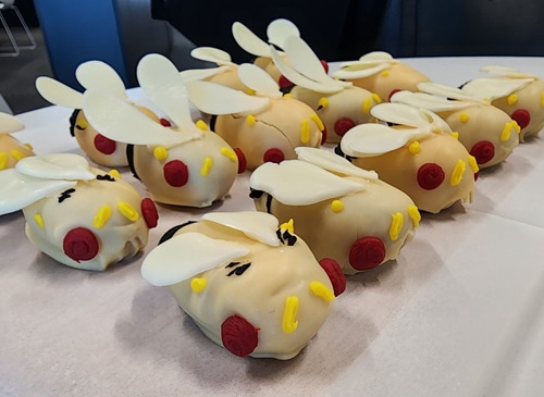 Small cakes decorated with icing to represent flies.