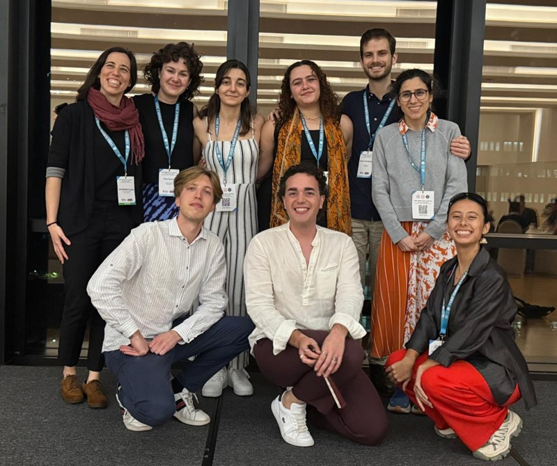 Group photo with six people standing at the back and three kneeling at the front.