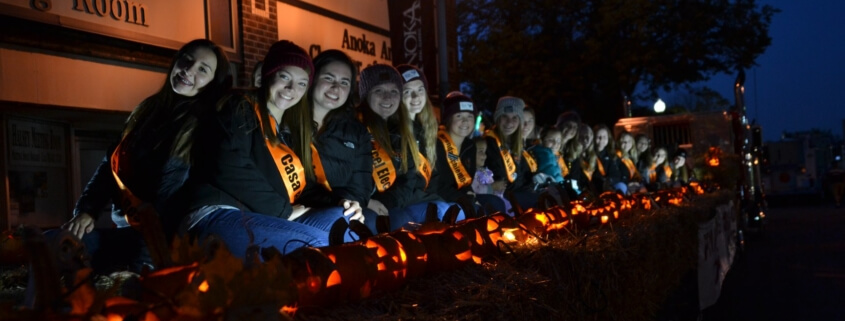 People holding lit pumpkins