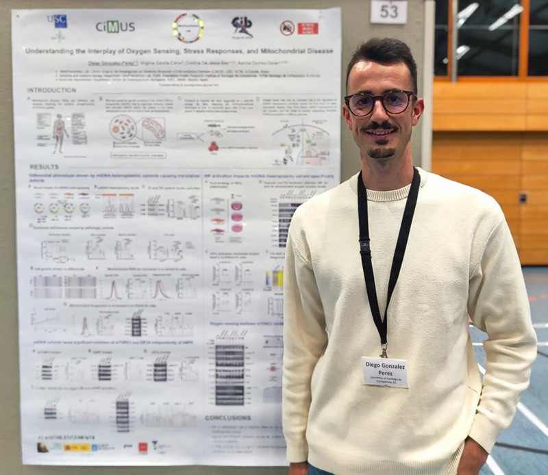 Photo of Diego González Pérez standing by his research poster and smiling at the camera.