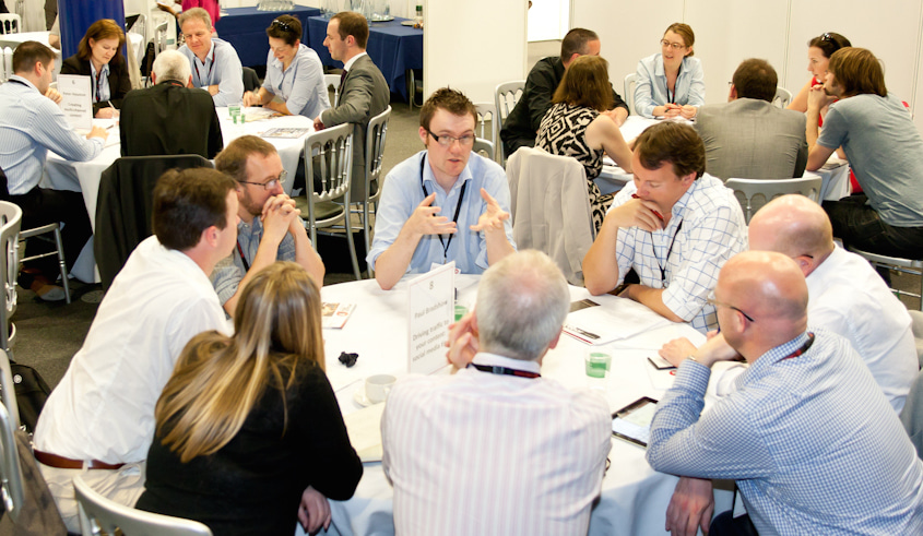 8 people sitting around a table