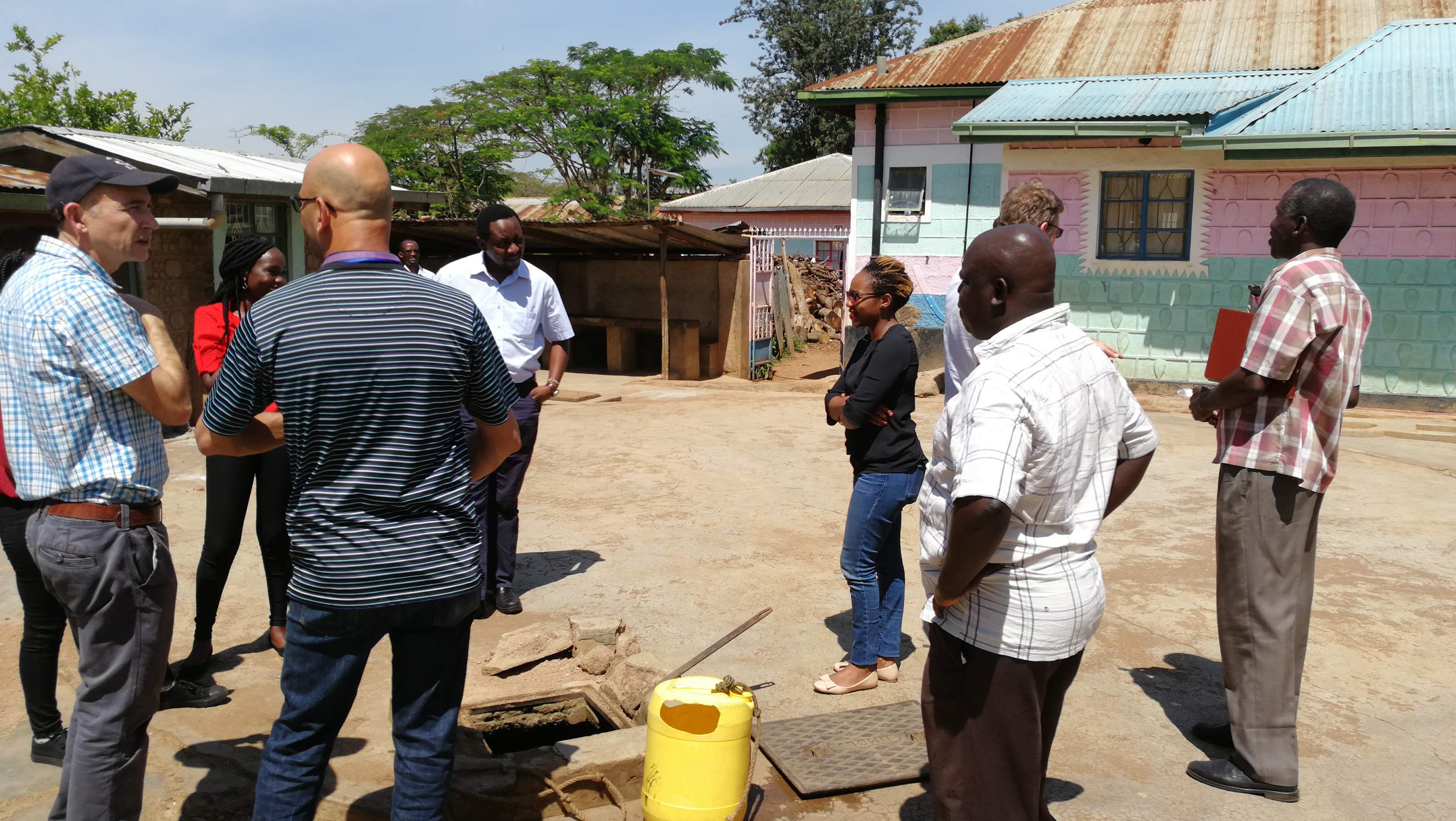 The OneHealthWater project team discuss a rainwater harvesting system