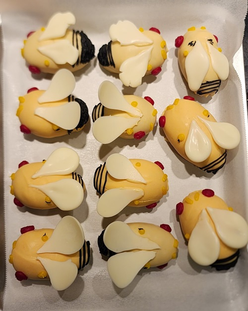 Small cakes decorated with icing to represent flies.