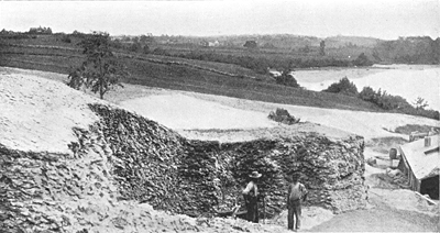 Men standing next to the Whaleback Shell Midden, before it was unfortunately mined for chicken feed in 1886. Image from Damariscotta River Association/ Maine Geological Survey.