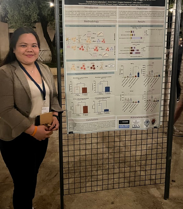 Florabelle Cabarrubias standing by her research poster.