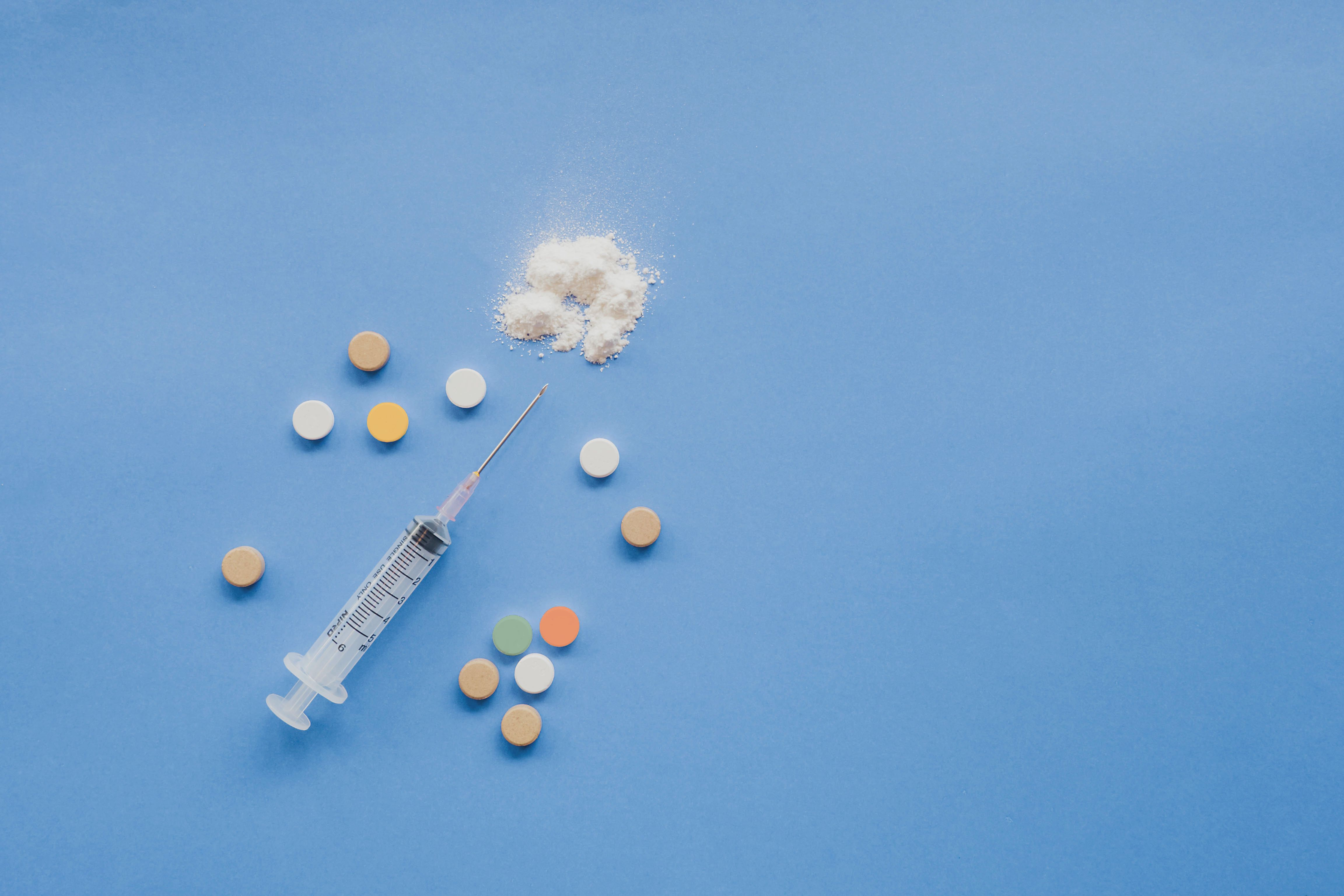 A needle, white powder and various tablets