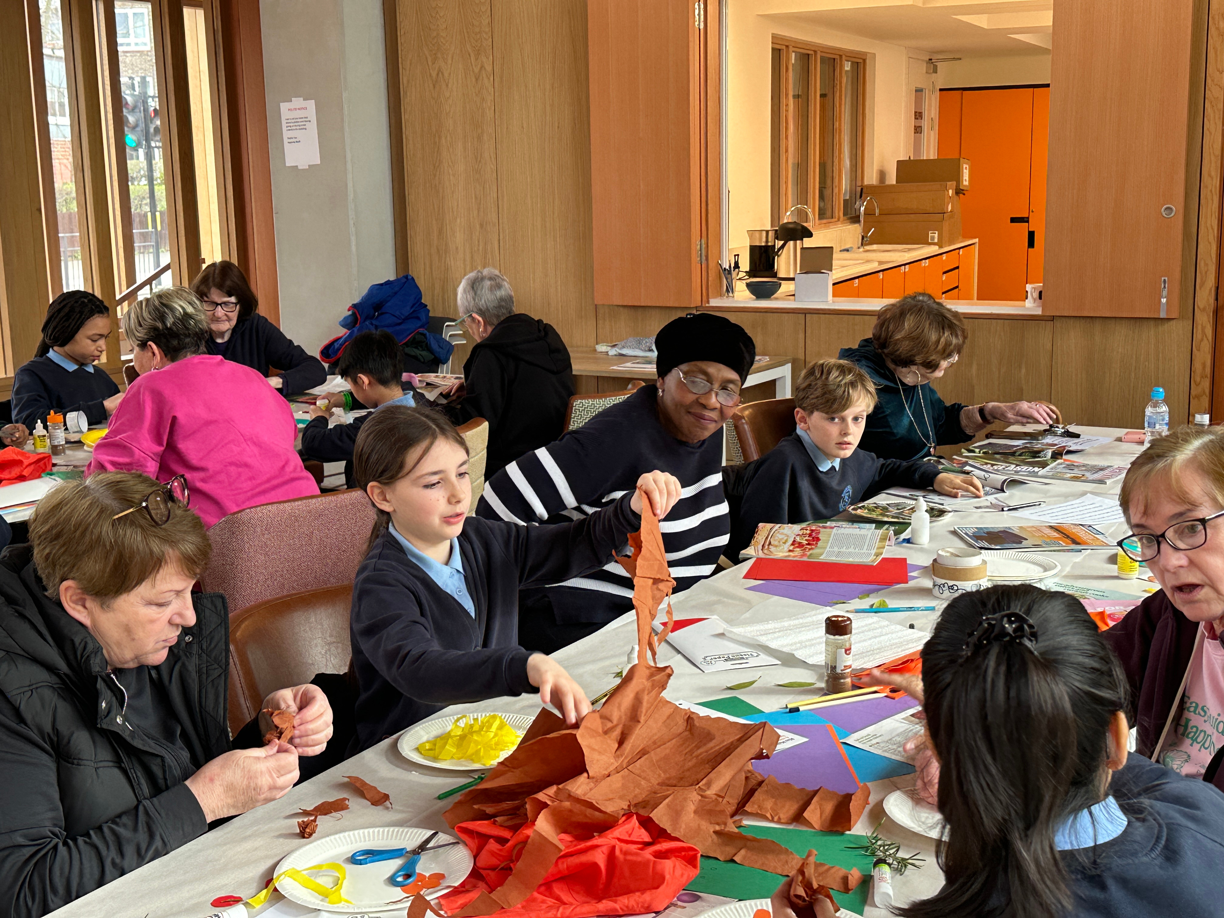 Participants at a multigenerational activity making food collages