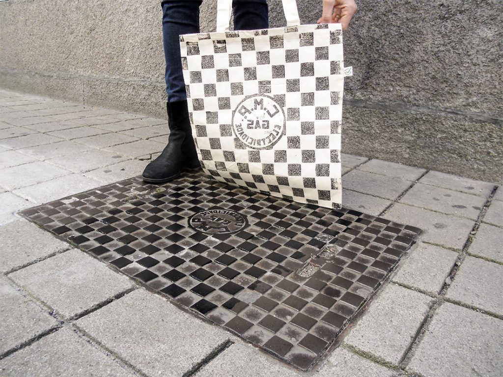 A picture of a bag being printed straight from a manhole cover in Porto. 