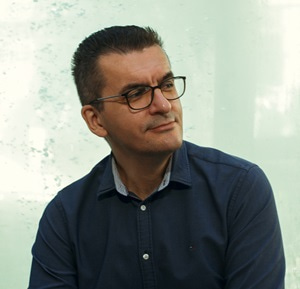 Ivan Spasojević Photo of Ivan Spasojević sitting and looking to the side.