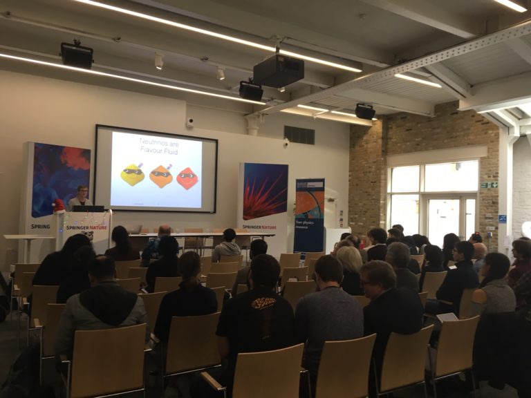 Linda Cremonesi giving a presentation to a room full of people sat in rows.