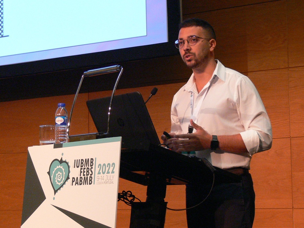 Photo of the author presenting at a podium.