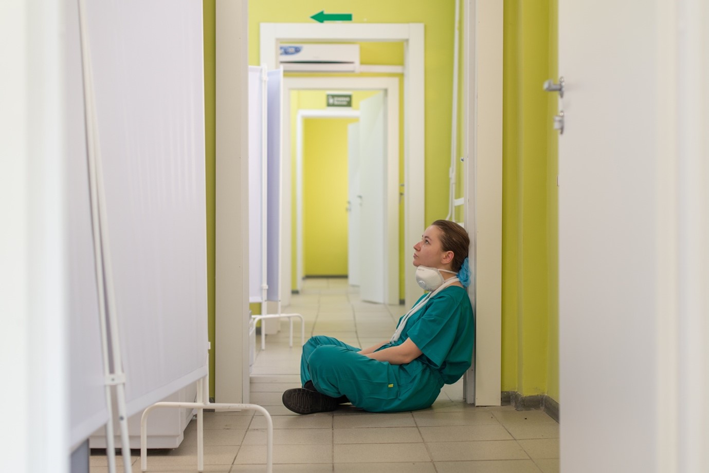 Nurse seated on the floor taking a break