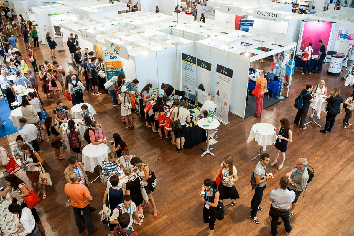 Conference participants visit the industry exhibition during the coffee breaks.