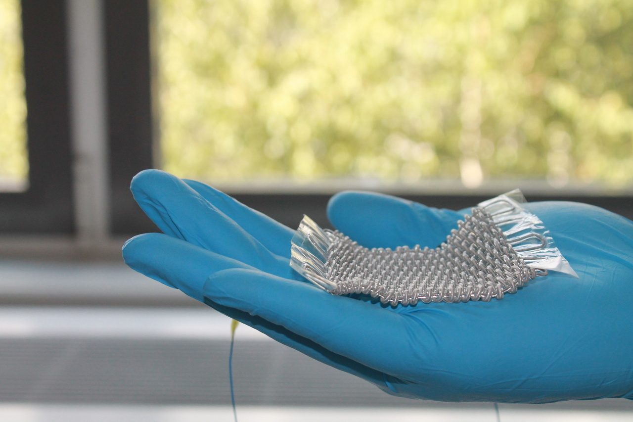 Harvesting mechanical energy with super-elastic fibers and textiles