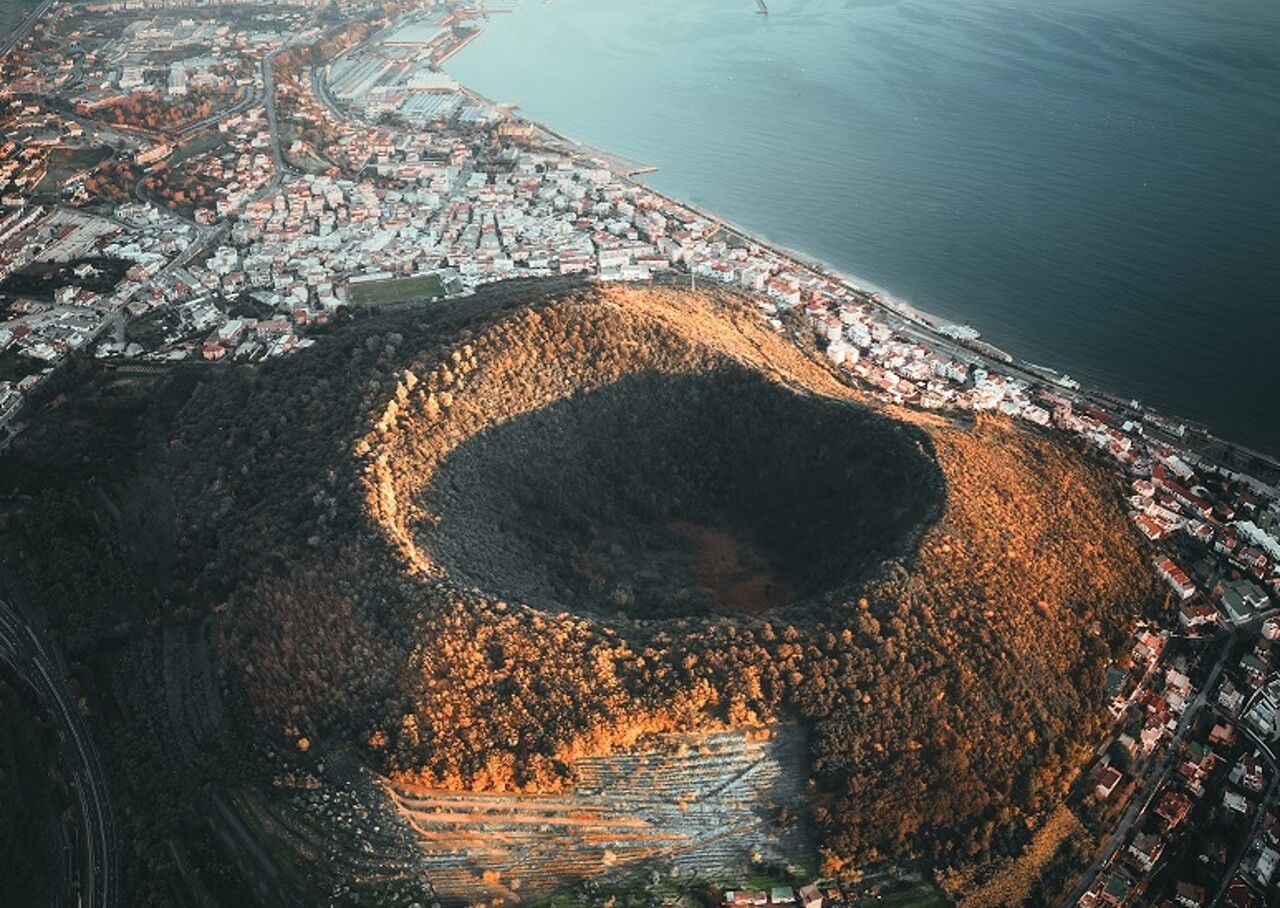 Do Energy Dissipation Processes at the Fracture Zone Put a Natural Cap on Campi Flegrei’s Quakes?