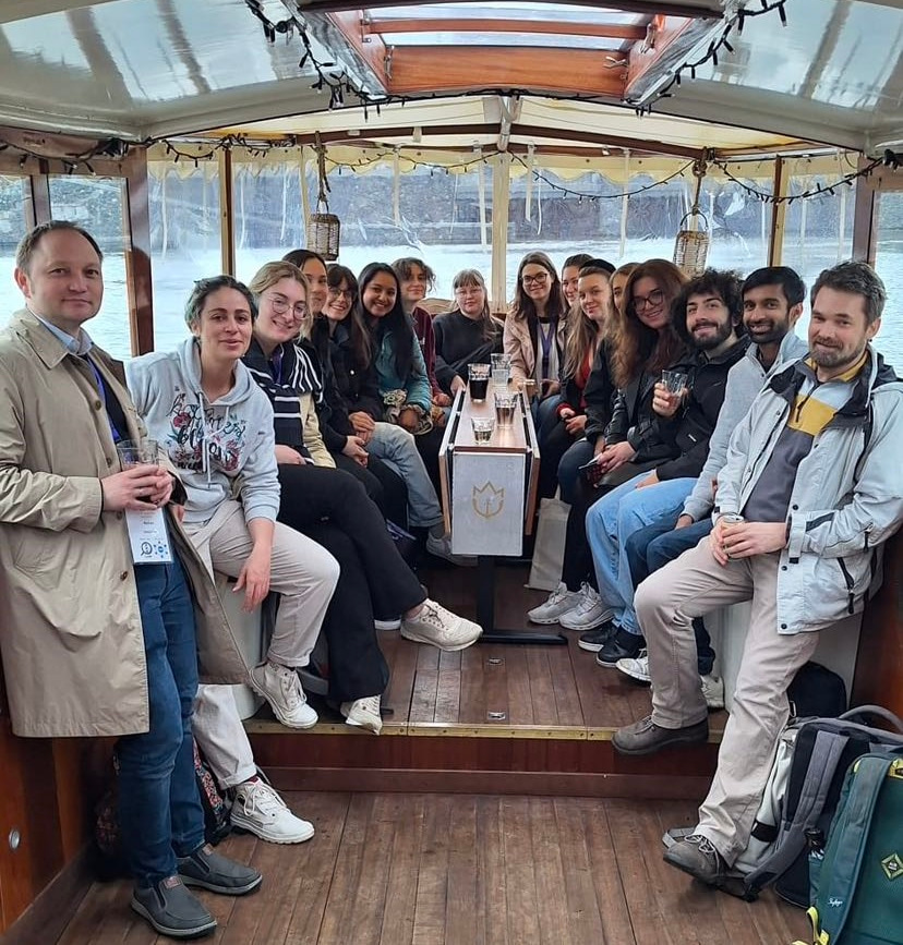 Group photo inside a canal boat in Amsterdam.