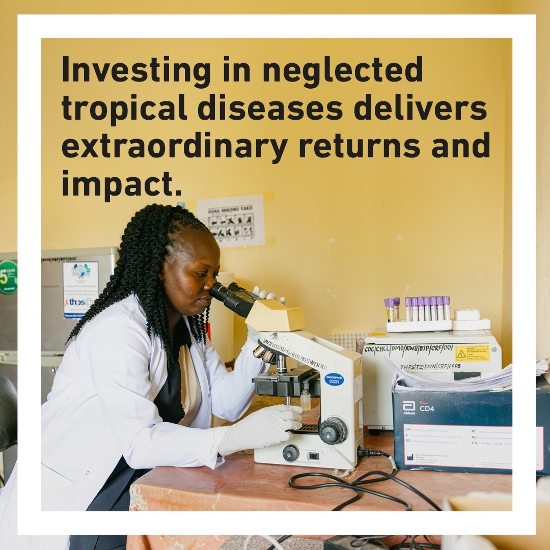 A woman in a white lab coat and gloves looks through a microscope in a laboratory, surrounded by scientific equipment and labelled boxes. Overlaid text reads: “Investing in neglected tropical diseases delivers extraordinary returns and impact.”