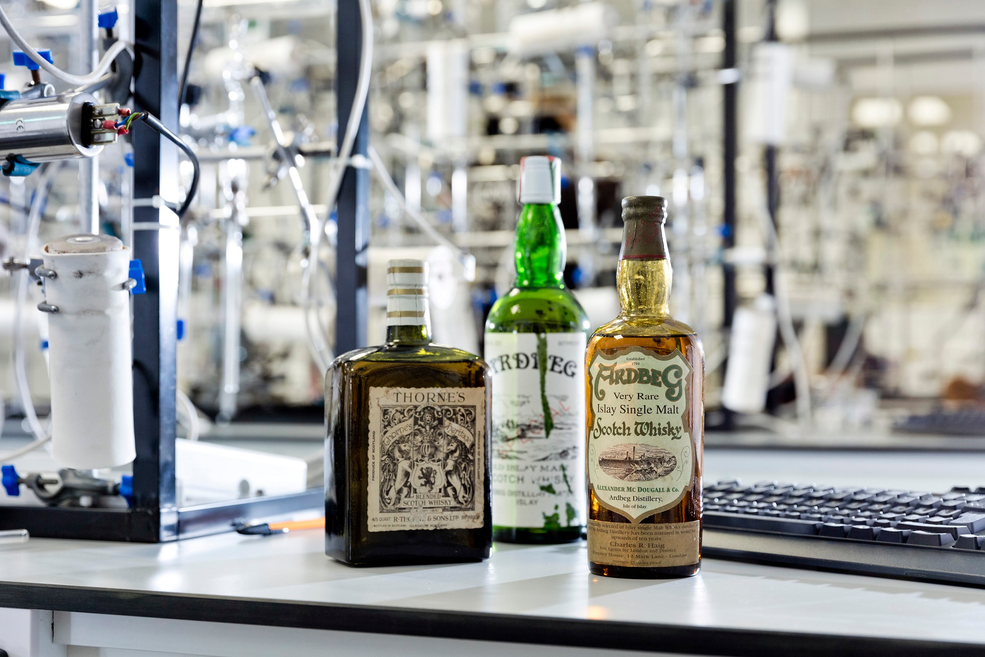 three whisky bottles on lab bench