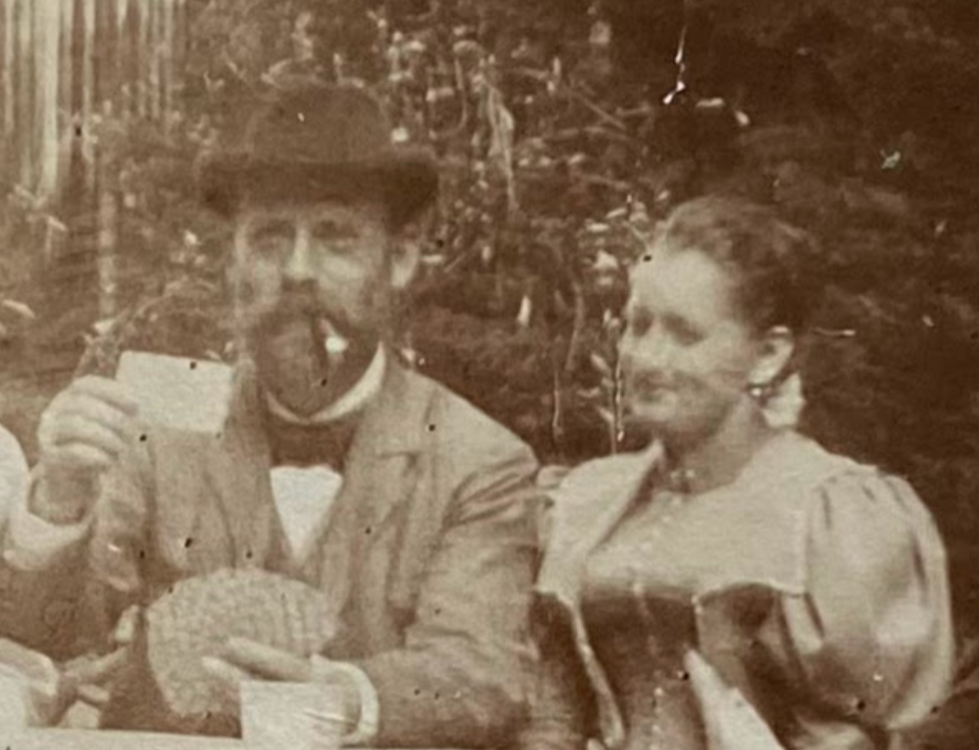 Old black and white photo of "Walther and Fanny Angelina in Saxony in 1897": A never-before-seen portrait of Walther and Fanny Angelina Hesse, with Walther holding up a card and Fayy smiling.