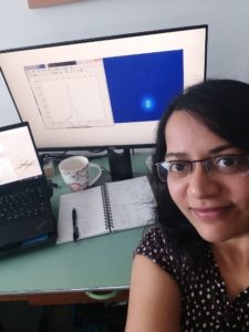 Dr Amruta Gadge working from home with an image of her BEC on screen