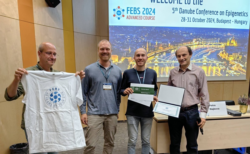 Photo of four men standing next to each other.