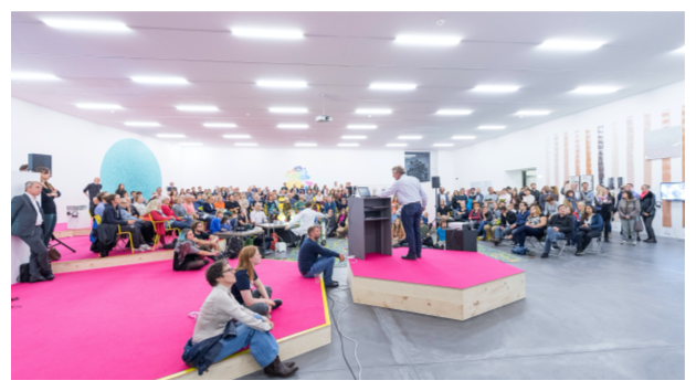 Photo of speaker and attendees at a lecture, taken from behind the speaker, showing a full room. The event took place during the long night of museums at the exhibition “100 Ways of Thinking". Photo credit to Frank Bruederli