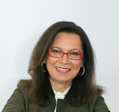 Portrait photo of Mübeccel Akdiş, smiling at the camera.