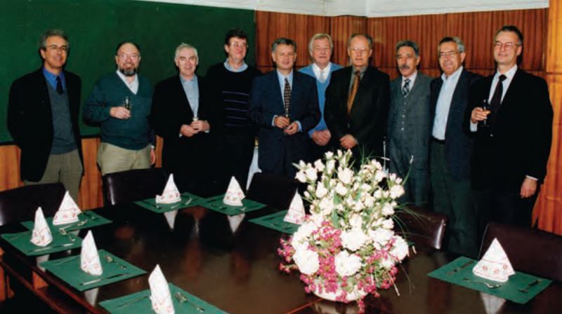 Group photo, standing behind a table.