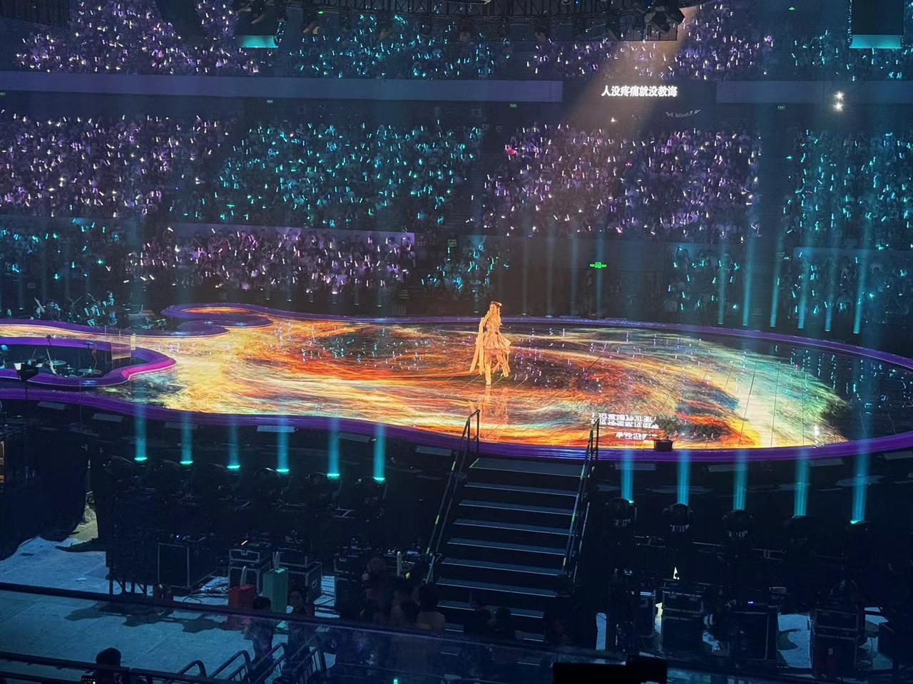 Interactive visuals dynamically following Zhang's movements, powered by reActor xr media servers, Notch visuals, and Blacktrax tracking technology.