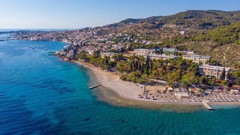Photo from the air of the beach and coastline of the island of Spetses, in Greece.