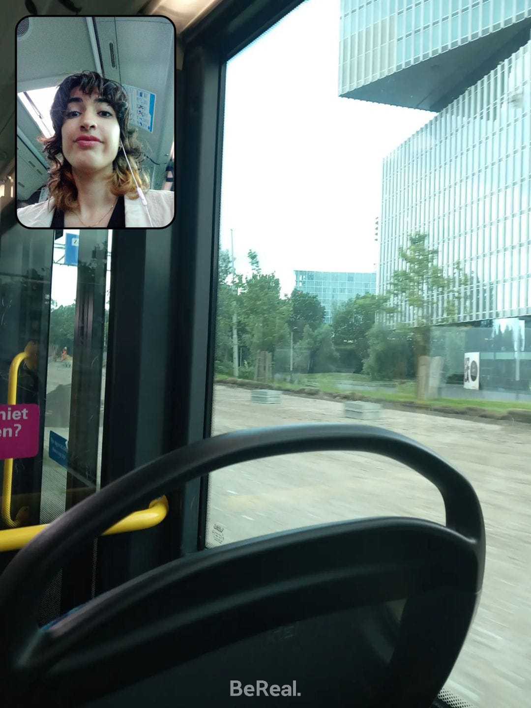 An image of a bus seat with a photo of a dark haired woman in the top left corner