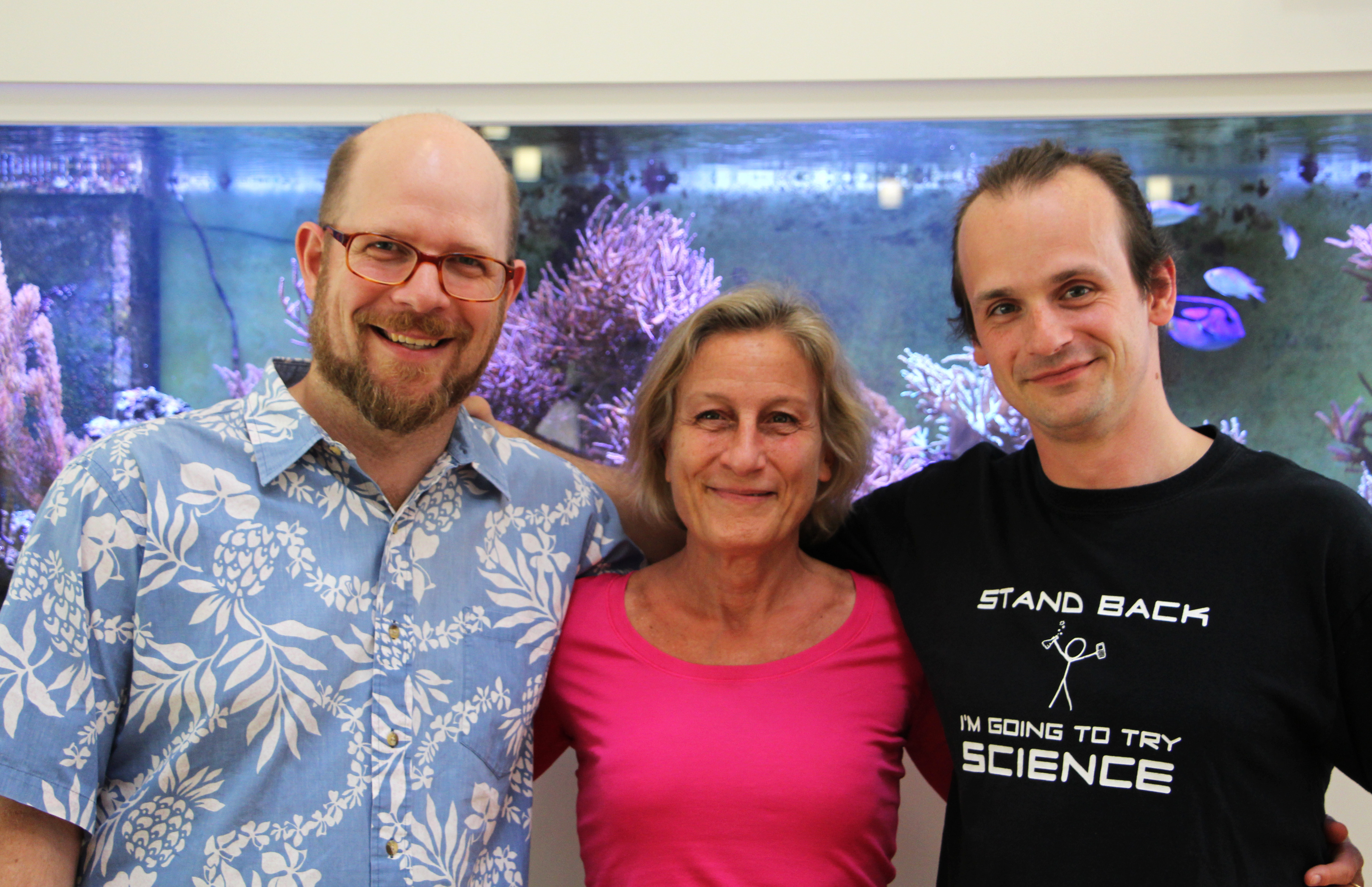 The lead authors and the PI in front of a treasure hidden in plain sight - an aquarium full of Trichoplax The lead authors and the PI in front of a treasure hidden in plain sight - an aquarium full of Trichoplax