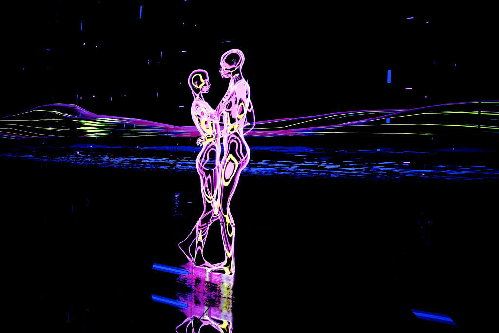 Photo of a light show depicting two figures