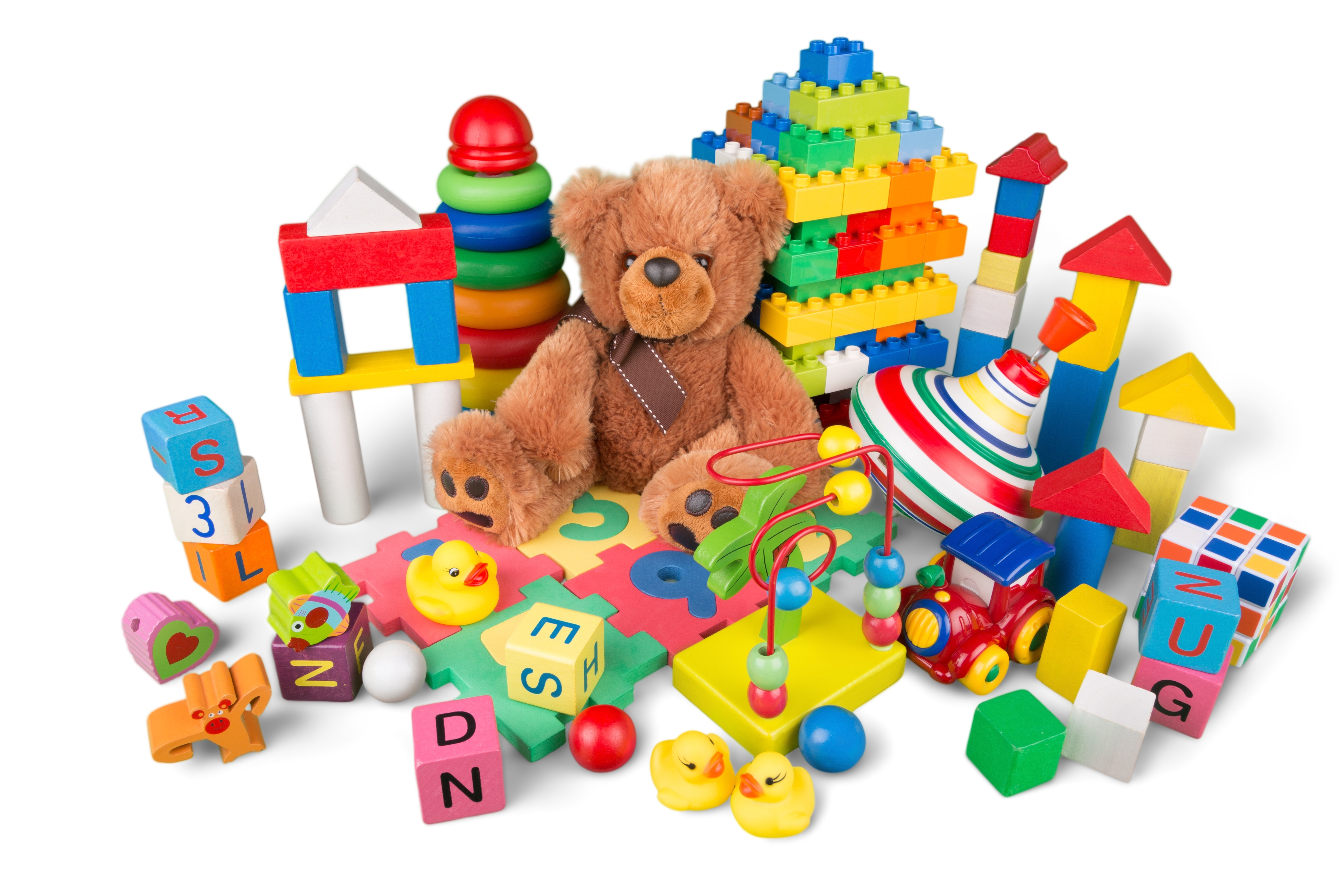 A group of colorful children's toys and a teddy bear